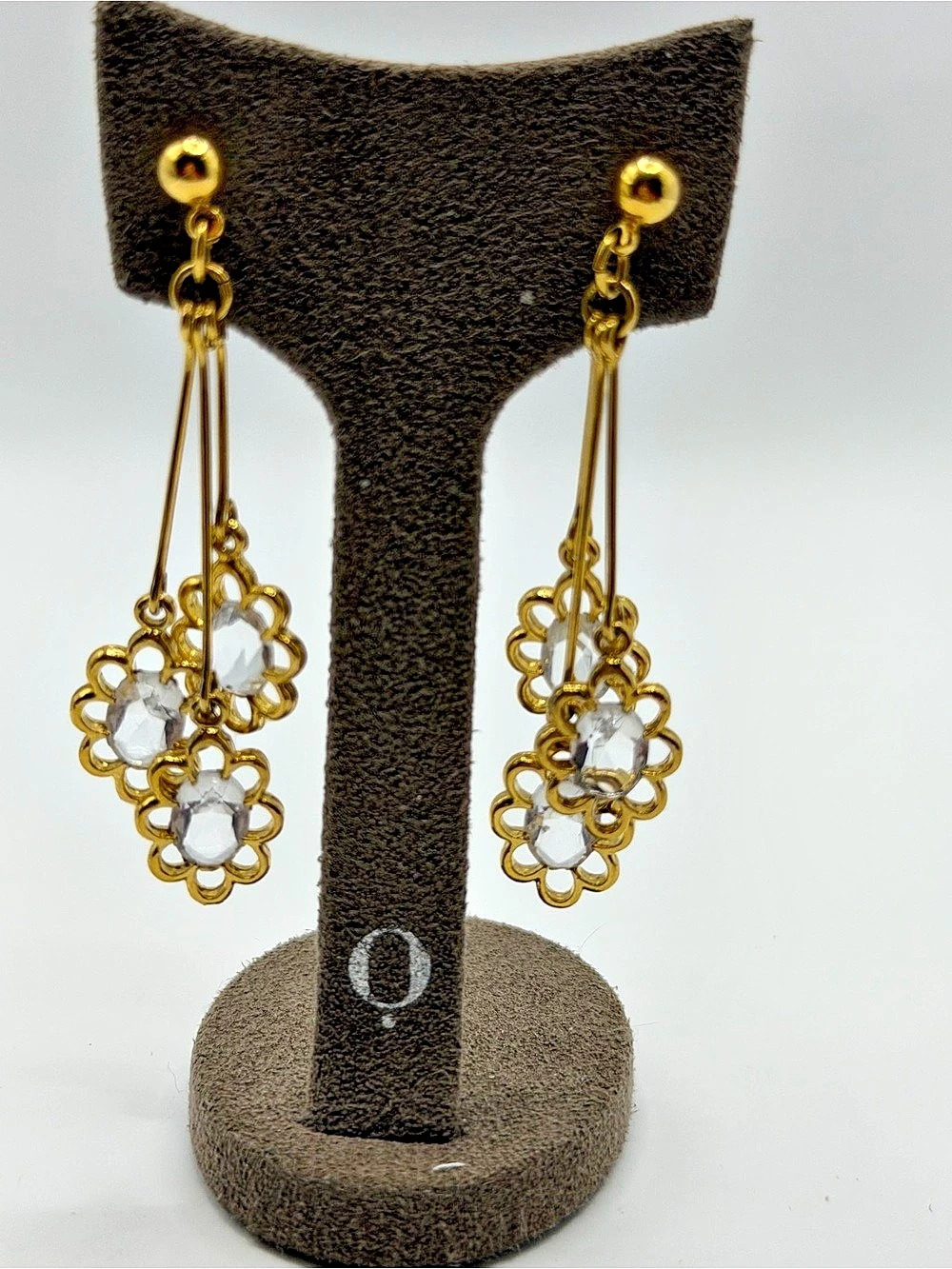 Modern gold tone floral and clear dangle earrings